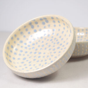 Two ceramic sauce bowls decorated in light blue