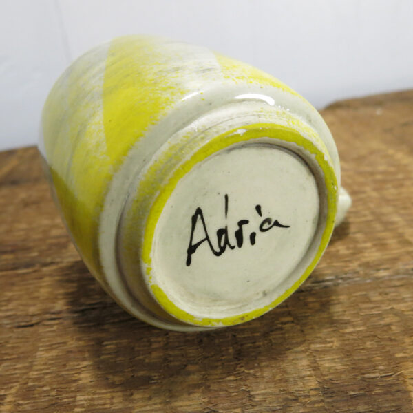 The underside of the cup, foot visible with signature, "Adria"