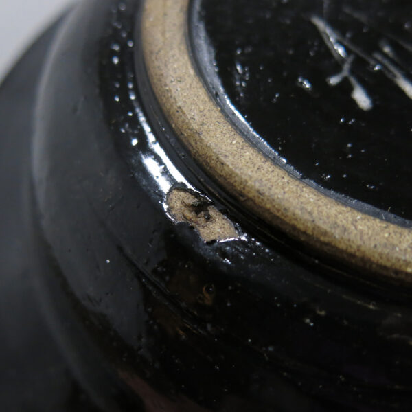 Close-up of a defect in the bowl, it's a small hole.