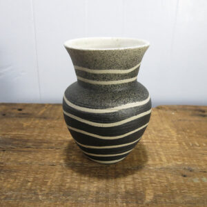 Black and white vase made of speckled clay.