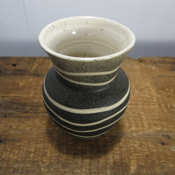 Black and white vase made of speckled clay.