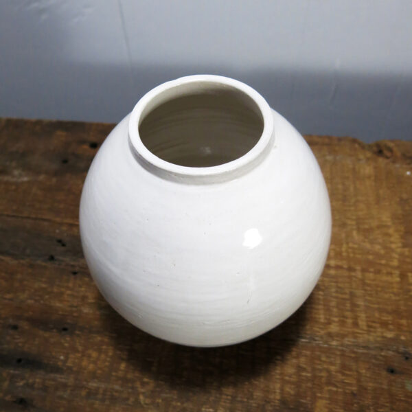 White ceramic vase seen from above.